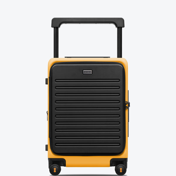 An orange and black carry-on suitcase with a wide handle and telescopic trolley system, featuring a textured exterior and dual-spinner wheels.