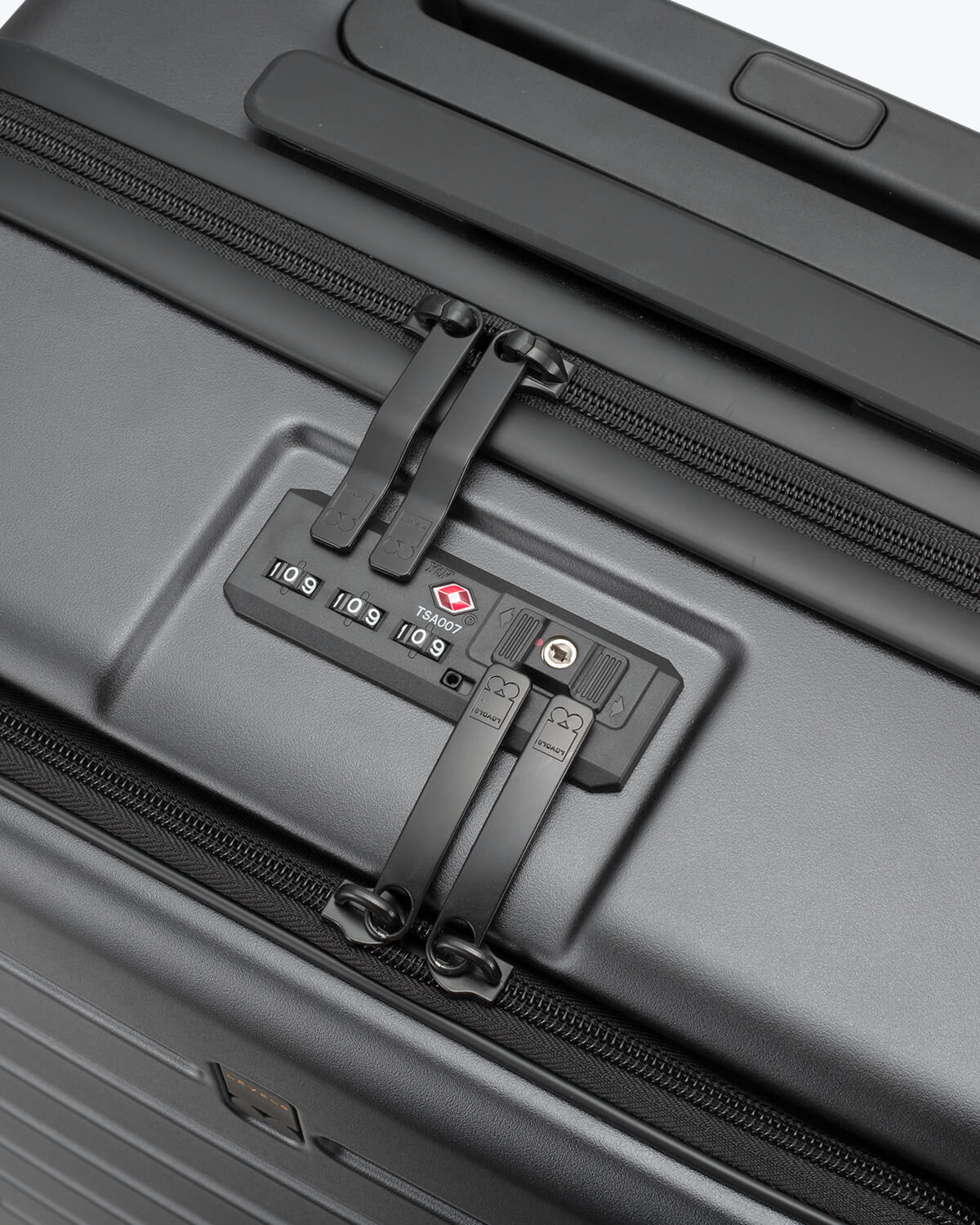 Close-up of the zipper and TSA lock on the Road Runner Carry-On 20" gray suitcase.