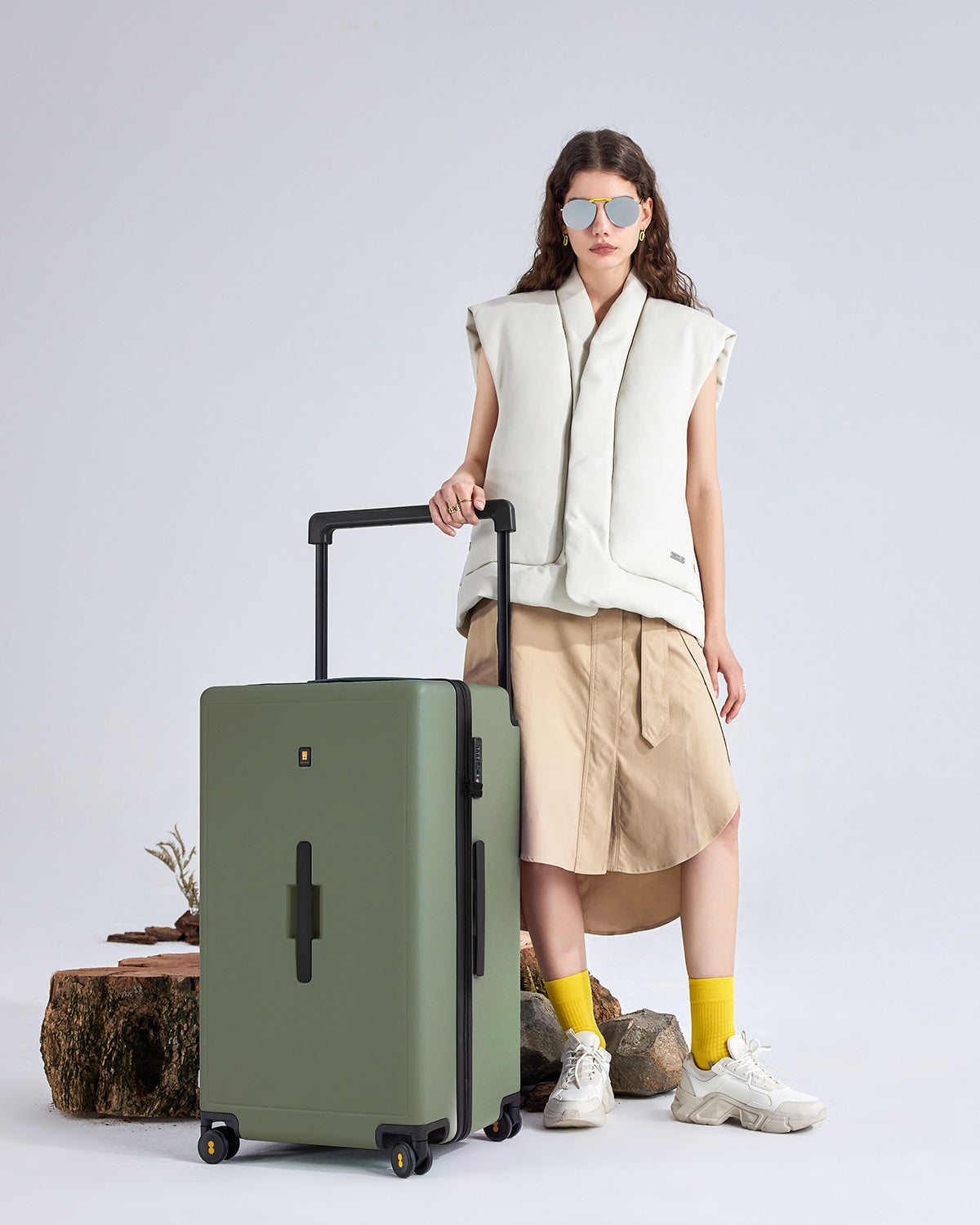 Woman using Voyageur Checked 28'' Darkolive suitcase on city street lifestyle scene